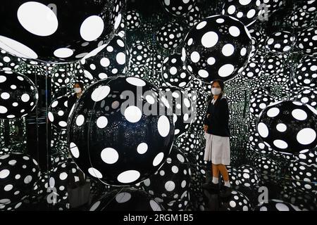 August 10, 2023, Hong Kong, Hong Kong, Hong Kong: A lady visits the art installation ''” DOTS OBSESSION ''“ ASPIRING TO HEAVEN'S LOVE, at M  Visual Culture Museum in Hong Kong. The artwork by Japanese artist Yayoi Kusama, who has lived in the United States between 1958 and 1975, features her famous polka dots and reflective mirrors inside a cubic environment which offers a kaleidoscopic visual experience. (Credit Image: © Daniel Ceng Shou-Yi/ZUMA Press Wire) EDITORIAL USAGE ONLY! Not for Commercial USAGE! Stock Photo
