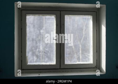 Window in building. Interior of building in detail. Window frame from inside. Light through glass. Stock Photo
