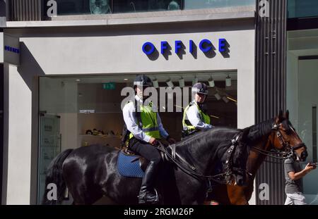 London, UK. 9th Aug, 2023. Police officers on horses patrol Oxford Street. A social media post reportedly organised a mass shoplifting event in the busy shopping street in central London, with police arresting and clashing with several young people outside shops during the day. (Credit Image: © Vuk Valcic/SOPA Images via ZUMA Press Wire) EDITORIAL USAGE ONLY! Not for Commercial USAGE! Stock Photo