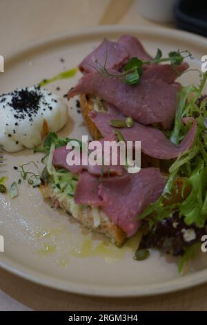 Beaf on bread with salad and egg Stock Photo