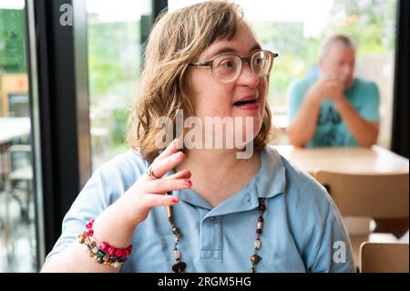 Portrait of a happy 40 yo woman with the Down Syndrome, Meerhout, Belgium Stock Photo