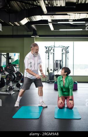 Energetic senior couple training in home using dumbbells and stability  ball. Old person healthy lifestyle exercise at home, workout and training,  sport activity at home on yoga mat. 35205305 Stock Photo at