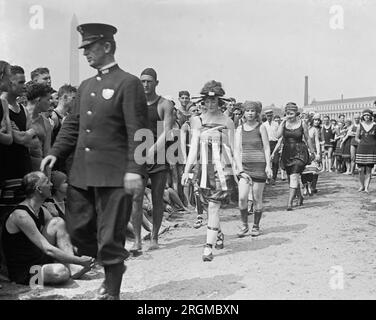 A policeman leads women during bathing beach parade, July 26, 1919 Stock Photo