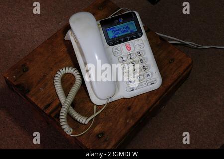 Old fashioned white corded telephone with large numbers Stock Photo - Alamy