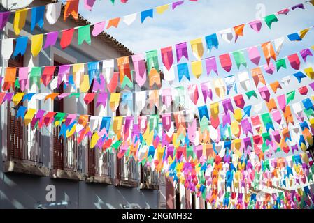 Salvador, Bahia, Brazil - June 15, 2023: Facades of old and historic houses in Pelourinho decorated with colorful flags for the feast of Sao Joao in S Stock Photo