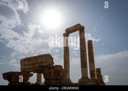 Ruins of Roman Hercules Temple with its cloumns on Citadel Hill in Amman, Jordan against blue sky with clouds Stock Photo
