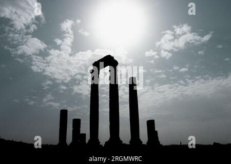Ruins of Roman Hercules Temple with its cloumns on Citadel Hill in Amman, Jordan against blue sky with clouds Stock Photo