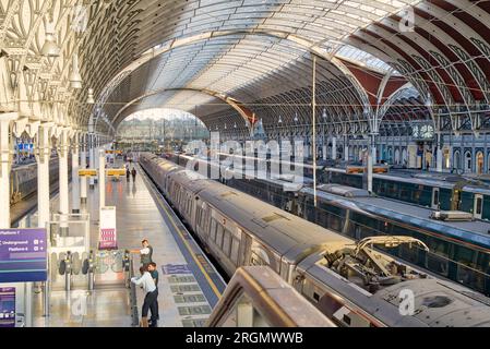 evening sun beam through arch roof top glasses onto Paddington station platform, GWR train is waiting for evening commuter passengers London UK Stock Photo