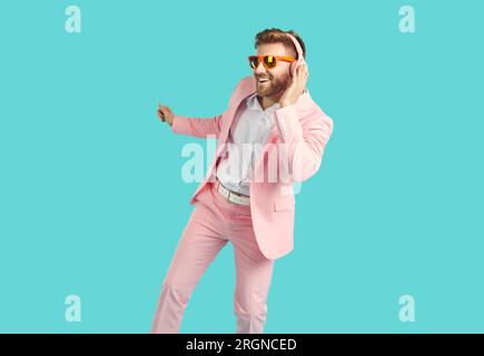 Cheerful happy young man in headphones dancing with happy smile Stock Photo