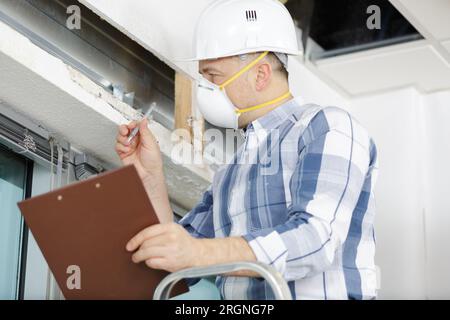 a professional construction worker is wearing a mask Stock Photo