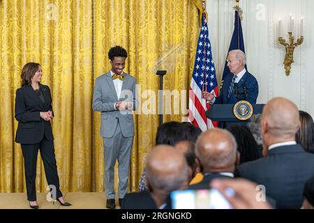 Reportage: Black History Month reception at the White House (2023) - President Joe Biden, joined onstage by Vice President Kamala Harris and DuWayne Portis Jr., Youth Leader at Chicago Youth Service Corps and High School Senior at Lindblom Math and Science Academy, delivers remarks at a Black History Month reception, Monday, February 27, 2023, in the East Room of the White House. Stock Photo