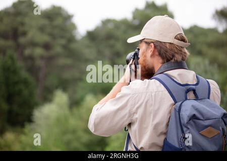 young professional traveler man with camera shooting outdoor Stock Photo