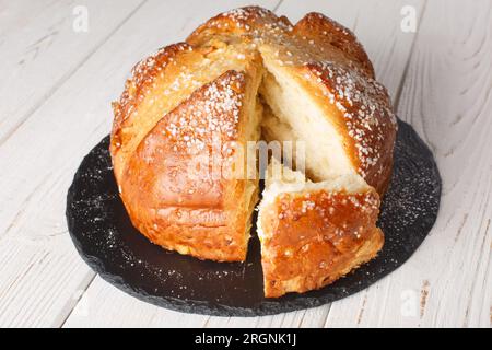 Homemade sweet brioche mouna bread close-up in a plate on the table. horizontal Stock Photo