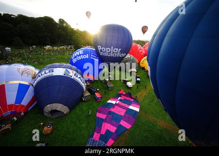 Hot air balloons are inflated during the mass ascent at the Bristol International Balloon Fiesta 2023. Picture date: Friday August 11, 2023. Stock Photo