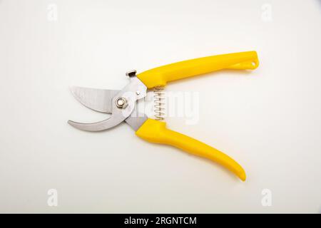 Garden pruning shears open yellow color handle isolated on white background, top view. Stock Photo