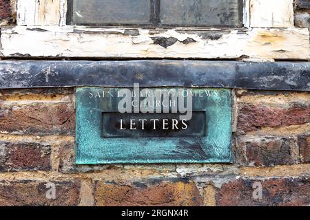 Old letterbox in the facade of St Bartholomew the Great Church on Cloth Fair, Farringdon, London, England Stock Photo