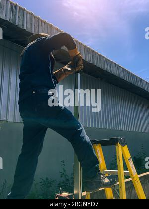 Cutting Metal, Man cutting steel blurred background, Construction concept Stock Photo