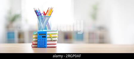 Stationery and notebooks standing on the table indoors. Stock Photo