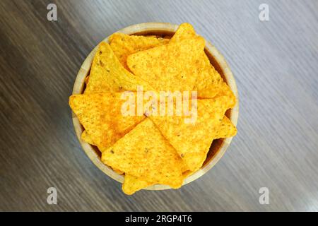 Nachos in a wooden bowl on wood table top view Stock Photo