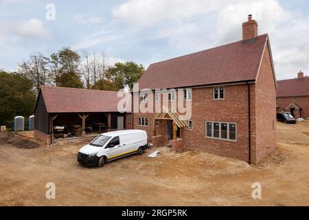 New build luxury housing development under construction with unmade roads and building materials Stock Photo
