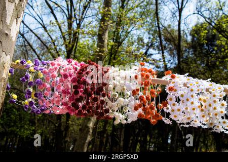 colorful crowns for sale made of fake flowers Stock Photo