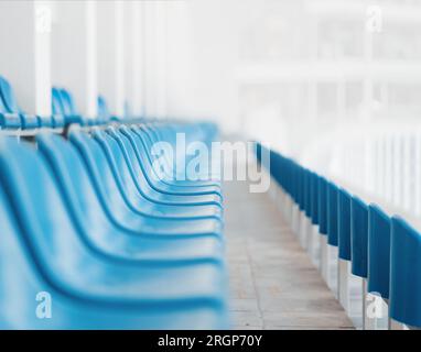 Rows of blue seats with numbers in a stadium. Perspective vanishing point view Stock Photo
