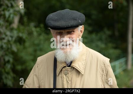 Happy old man. Grandfather's gray beard. Stock Photo
