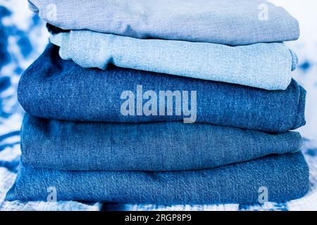 A stack of different colored blue denim Stock Photo
