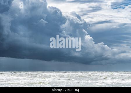 Beautiful rough sea with big waves, and dramatic cloudy sky with big dark clouds before the storm and rain Stock Photo