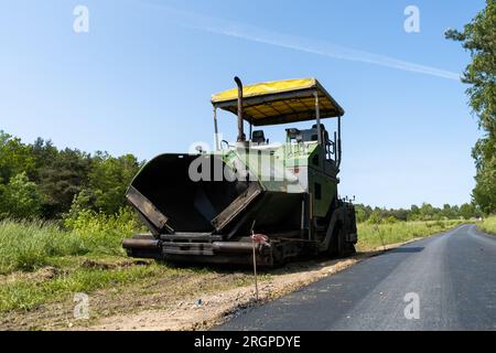 Paver finisher equipment. Crawler paving machine for laying asphalt. Stock Photo