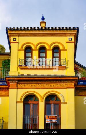 Seville, Spain, Colonial style building facade in an overcast sky. Classic Spanish style in an old structure. Stock Photo