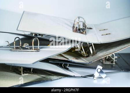 Heap of empty old file folders or ring binders and a small usb-stick, concept for space-saving digitalization in bureaucracy, administration and busin Stock Photo