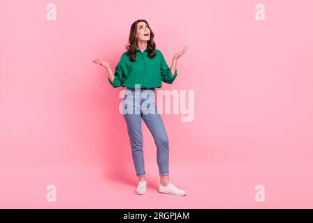 Full size photo of negative unsatisfied girl raise hands look up empty space asking why isolated on pink color background Stock Photo