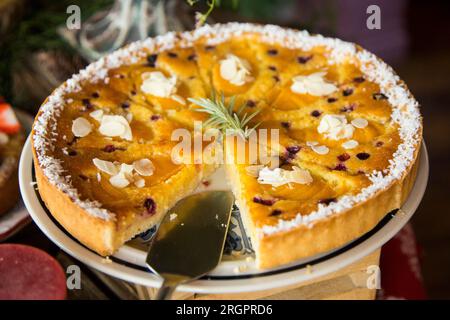 Peach coconut  pie with blueberries in a pastry shop in the city of Paris in France. Stock Photo