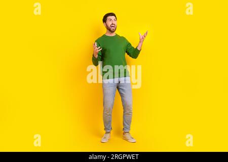 Full body photo of angry young business worker tired mad guy hands up grimacing why his partners idiots isolated on yellow color background Stock Photo