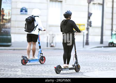 Paris, France. 08th Aug, 2023. Illustration picture shows people using a self-service electric scooter in streets of Paris, France on August 8, 2023. All self-service e-scooters will come to a stop in Paris as of 1 September after a referendum. Credit: Victor Joly/Alamy Live News Stock Photo