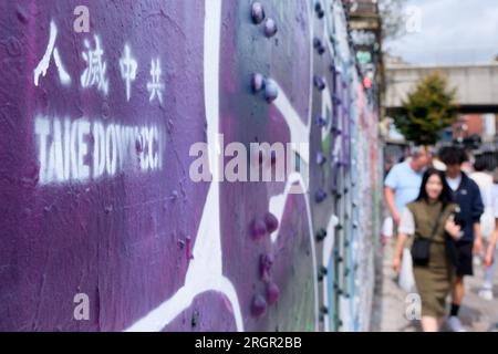 Brick Lane, London, UK. 11th Aug 2023. The ongoing battle of Chinese graffiti on the wall in Brick Lane, London. Credit: Matthew Chattle/alamy Live News Stock Photo