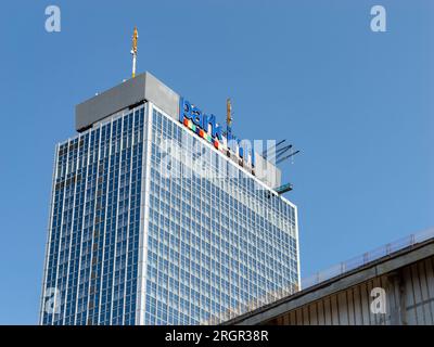 Park Inn hotel at the Alexanderplatz. The high rise building with the logo sign on the top is viewed from a low angle. It belongs to Radisson. Stock Photo