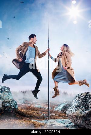 Young man and woman pole dancers in casual autumn clothing jumping, creative concept Stock Photo