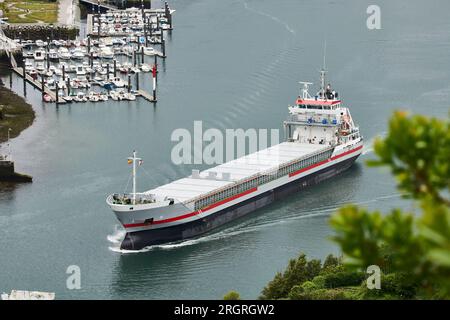 View of the cargo ship left the Port of Pasaia, Guipuzcoa, Basque Country, Spain, Europe. Stock Photo