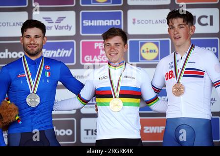 Belgium's Remco Evenepoel (centre) with the gold medal, Italy's Filippo Ganna (left) with the silver medal and Great Britain's Joshua Tarling with the bronze medal after the Men Elite Individual Time Trial on day nine of the 2023 UCI Cycling World Championships in Stirling. Picture date: Friday August 11, 2023. Stock Photo