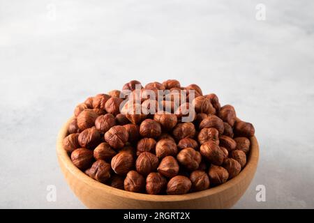 A bowl full of peeled hazelnuts  on bright background,closeup Stock Photo