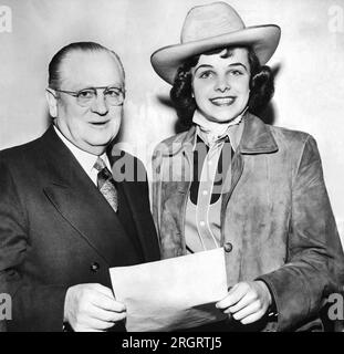 San Francisco, California:  March 24, 1950 High school student Dianne Goldman wearing a cowboy hat with San Francisco mayor Elmer Robinson. She is a member of the St. Francis Riding Academy drill team. Stock Photo