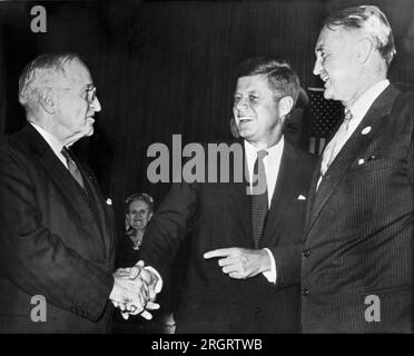 St. Louis, MIssouri:  October 3, 1960 Former President Harry S. Truman greets Senator John F. Kennedy as the Democratic candidate for President arrives for a speaking engagement. Senator Stuart Symington is at right. Stock Photo