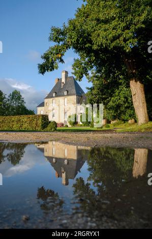 French chateau with reflection in puddle Stock Photo