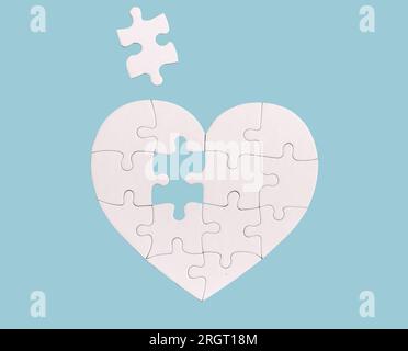 Missing piece puzzle, lacking part in whole heart, love concept. Stock Photo