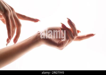 Woman applying cream on her hands Stock Photo