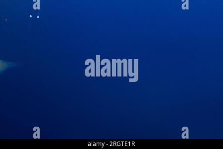 Calm clear blue sea water background. Blue azure sea water texture. Stock Photo