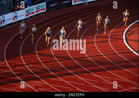 OSTRAVA, CZECHIA, JUNE 27, 2023: 400m Female Race Amidst Light and Shadow in Track and Field Event Stock Photo