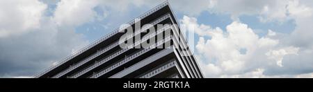 Banner modern house against a blue sky with clouds Stock Photo